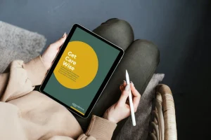 Person using a tablet showing “Get Care Wise” care advice while sitting on a sofa at home
