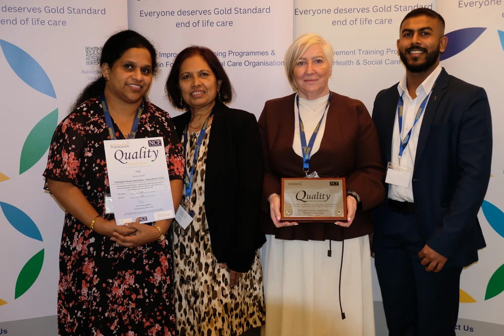 Torkington House staff members collecting the Gold Standard Frameworks accreditation