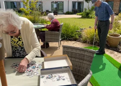 Residents enjoying puzzles and outdoor activities at Clarendon Lodge Care Home