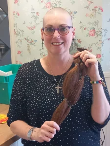 Michelle George, pictured after shaving her head for the dementia research fundraiser