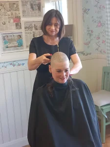 Michelle George's hair being shaved by The Orchards in house hairdresser