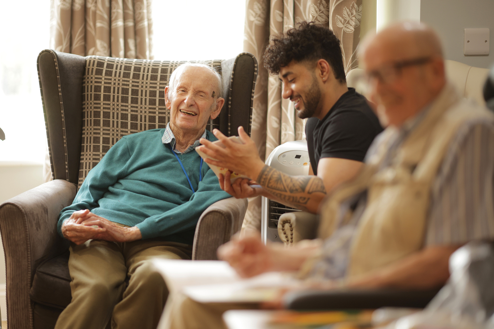 A resident enjoying time with a Greensleeves Care colleague