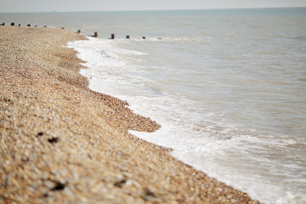 Pebble beach shoreline with gentle waves, Grosvenor House