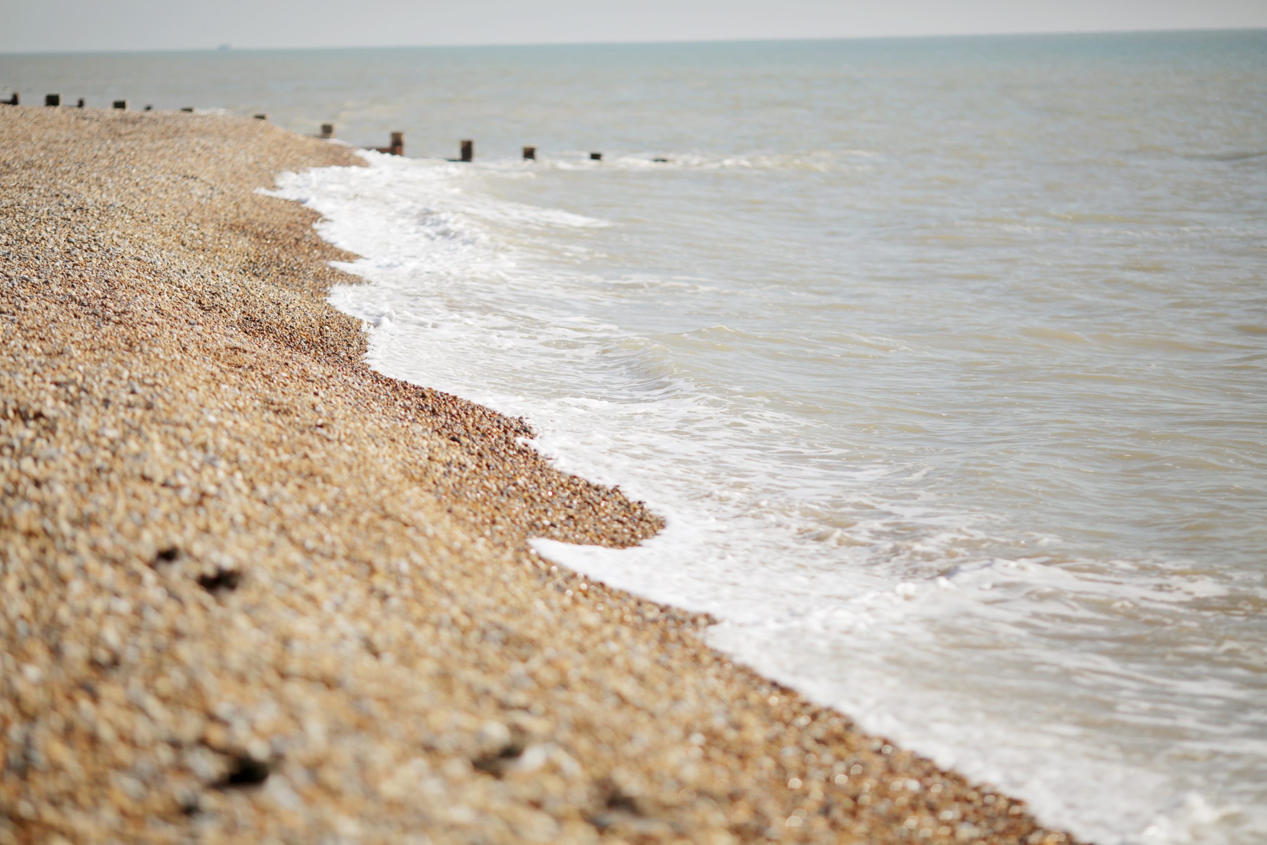 Pebble beach shoreline with gentle waves, Grosvenor House