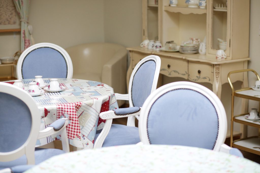 Breakfast table setting and blue chairs at Harleston House