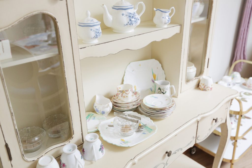 Antique china teapot and dinner service display in Harleston House
