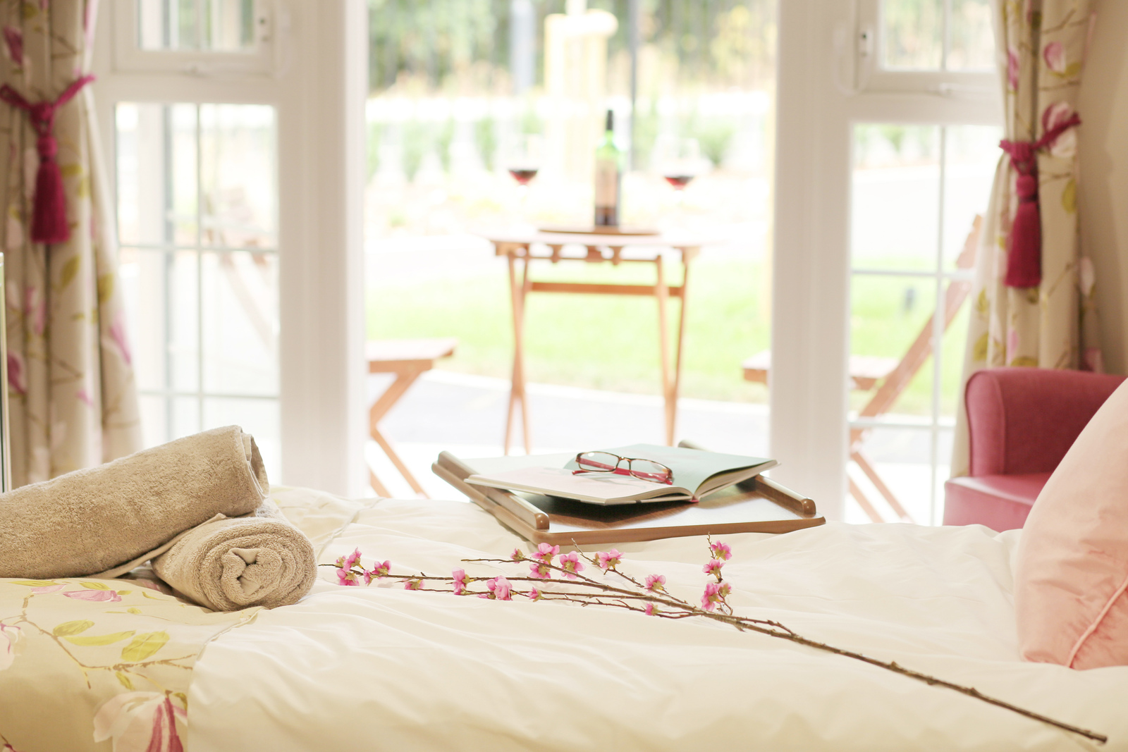 Lavender inspired bedroom with floral decor and sunlit patio view