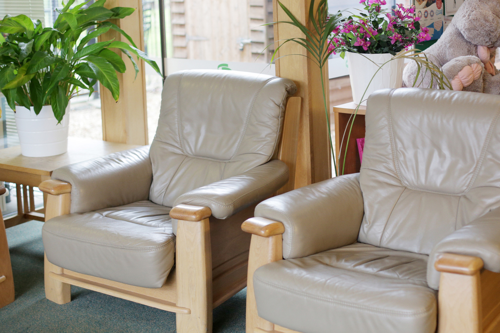 Cream leather armchairs with floral display at Pelsall Hall