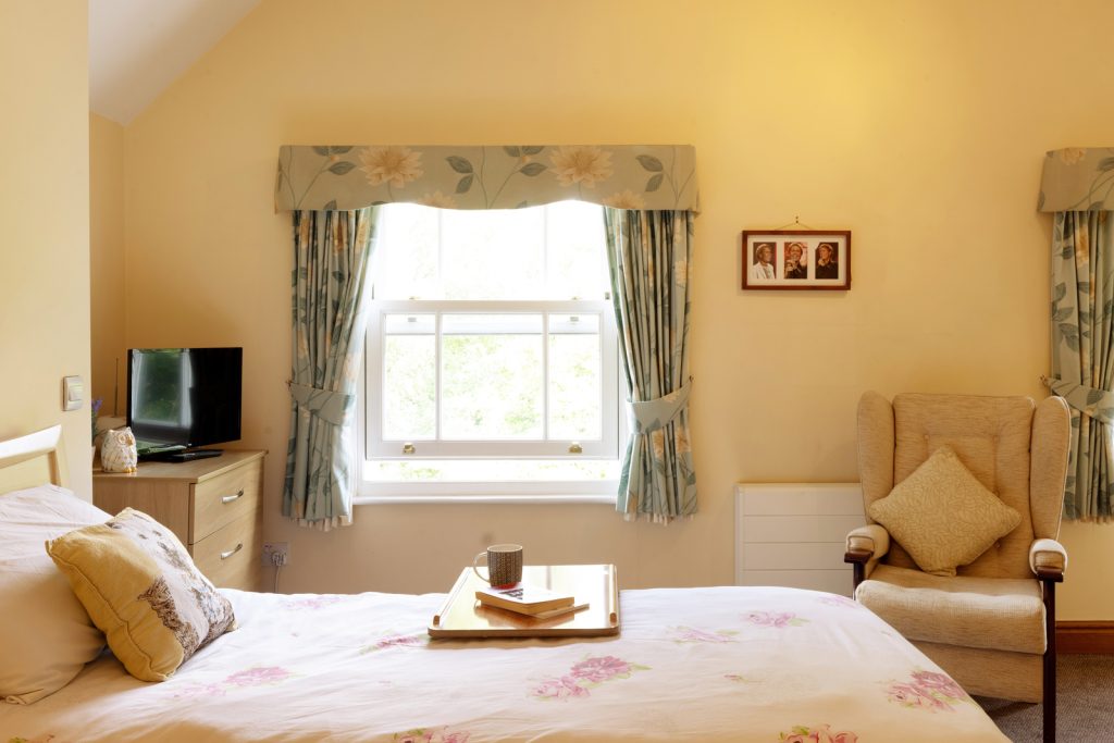 Floral curtained bedroom window at Pelsall Hall, Staffordshire