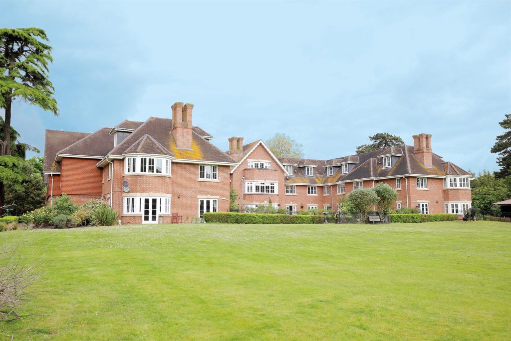 Manor House Exterior with Lush Lawns and Brickwork