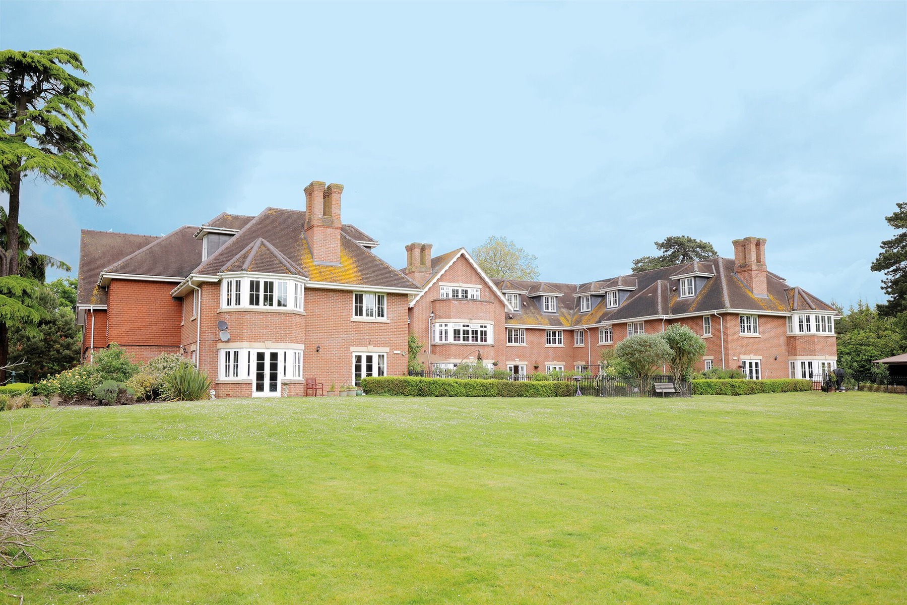 Manor House Exterior with Lush Lawns and Brickwork