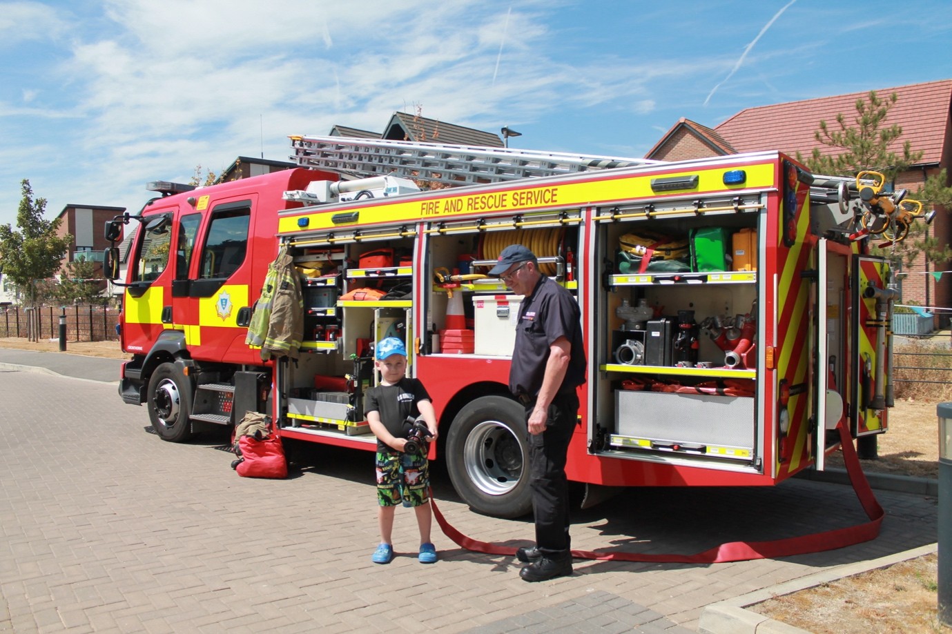 Fire engine crew and children at Buckler’s Lodge summer fete