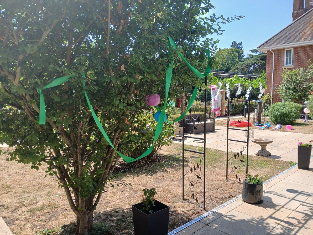 Decorated garden tree with ribbons for The Manor’s midsummer