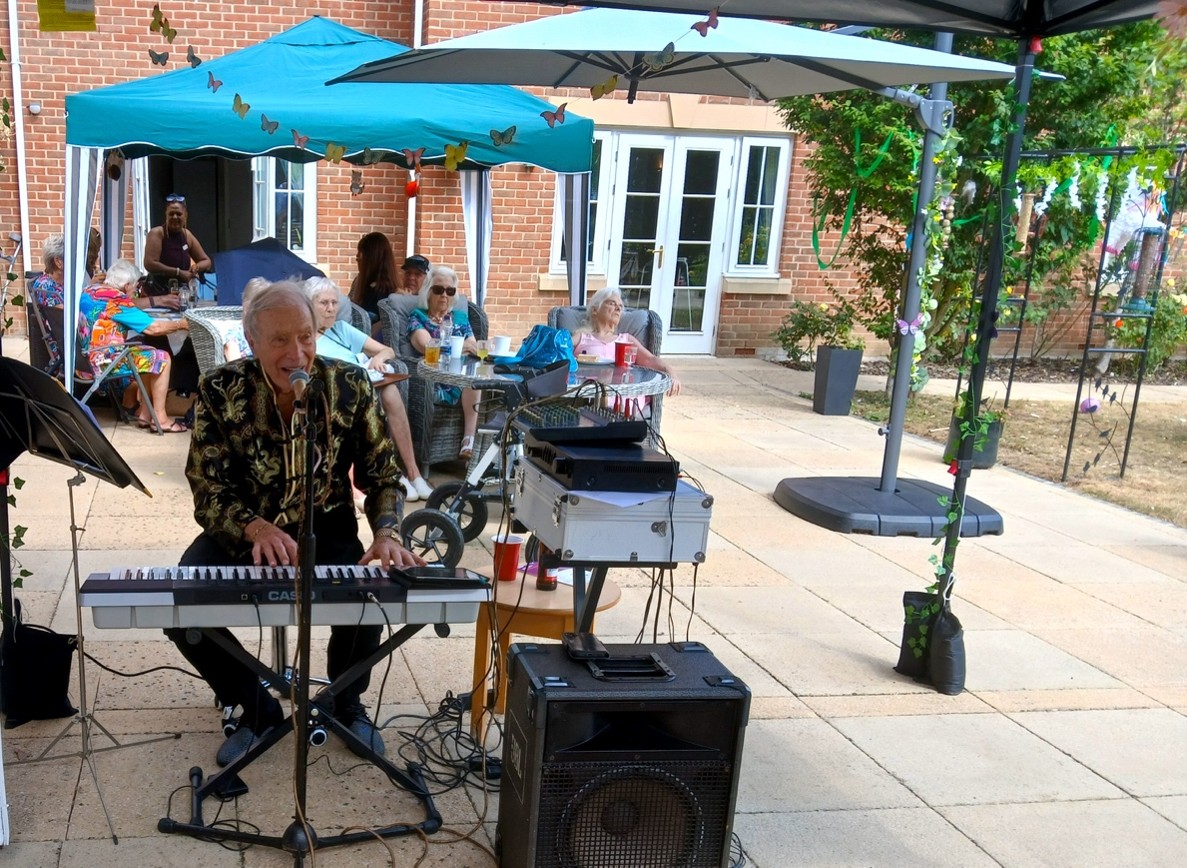 Elderly residents enjoy live music at The Manor’s midsummer event