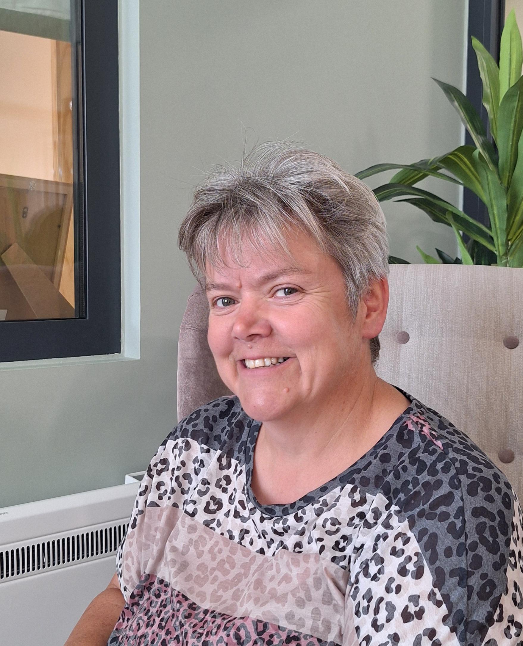 Care Home Manager, Anita smiling at Harleston House in a bright lounge