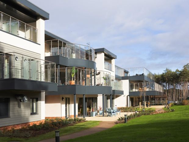 A landscaped garden path beside a Greensleeves care home
